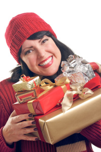 Attractive Woman Holds Holiday Gifts Isolated on a White Background.